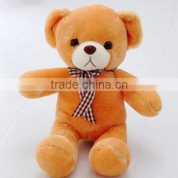 brown plush bear with scarf