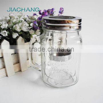 Decorated candle in clear glass jar