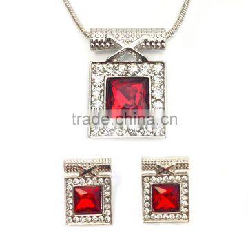 large red crystal surrounded by clear microset crystals necklace and earring