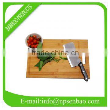 Square bamboo cutting board with a handle and a groove