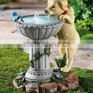 garden fountain with bird and dog drinking water