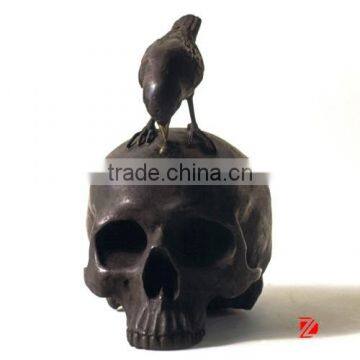 Bronze skull statue with bird sculpture for decoration