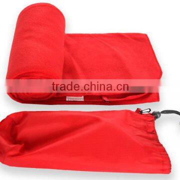 Polar fleece travel blanket in a drawstring bag with hook connection