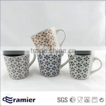 Stoneware conical shaped matte finished cups with handpainted flowers