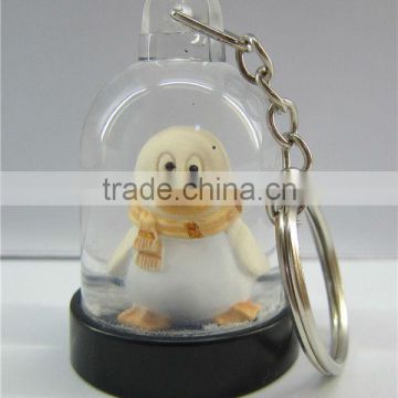 Plastic snow globe penguin key chain