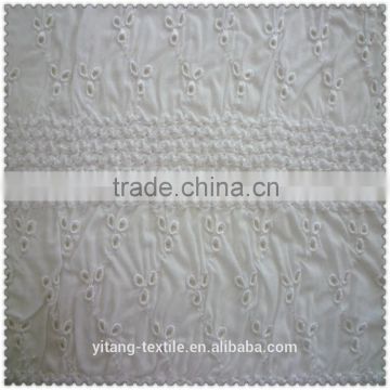 white cotton fabric with embroidered pattern