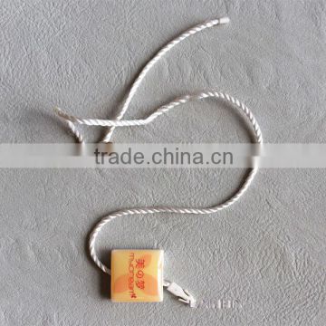 Double insertion crystal string seal tag for high end garments