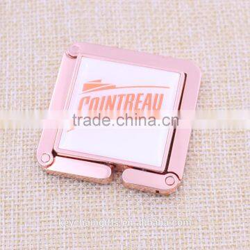 Hot sale square rose gold bag purse hanger/ foldable bag purse holder with epoxy sticker logo