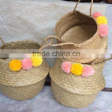 Best selling natural seagrass belly basket with orange pompoms