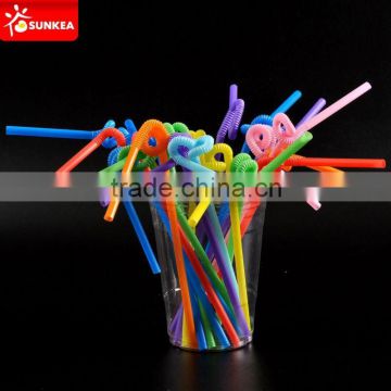 Colorful straws with spoon