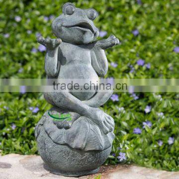 Bronze sculpture of frog sittng in the ball