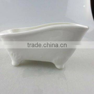 stocked white ceramic boat-shaped saucer dish