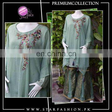 Western fusion with eastern unique touch Green Blossoms cape style with ghararah pants. Fine embroidery and embellishment work.