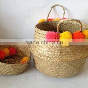 High quality best selling eco-friendly Natural seagrass storage basket with yellow & orange pompoms from Vietnam