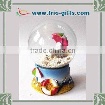 Beach scene glass water globe with polyresin base