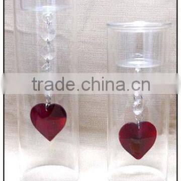 tall glass candle holder with red heart pendants