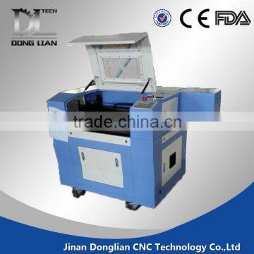 6040 small model alibaba hot sale jinan donglian used co2 laser cutting machine for pvc/glass