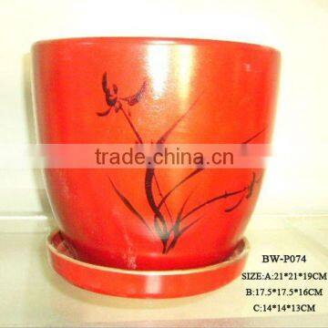 red ceramic flower pot with saucer