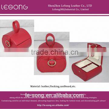 red cylindrical jewelry box with handle and metal fastener