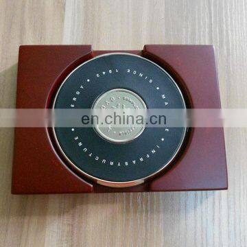 two metal coasters packed in a wood base