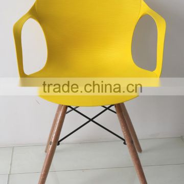 Colorful plastic chair with beech wood legs