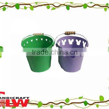 set of 2 handmade and durable, circular shaped home storage buckets with wooden handle and flower pattern