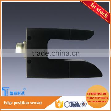 edge position sensor for textile material handling machine web guiding