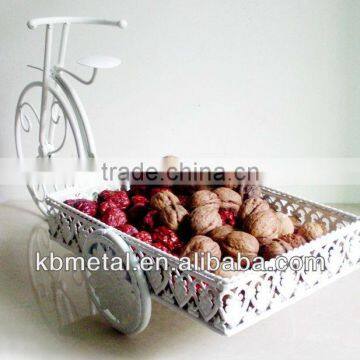 white three-wheel cart fruit plates