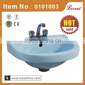 Wall mounted light blue colored wash face basin