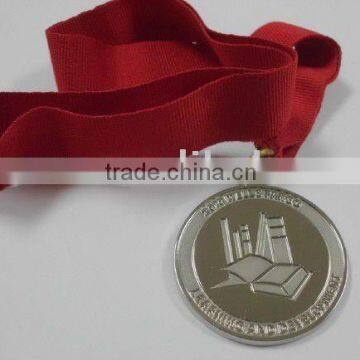 Silver souvenir coin with ribbon