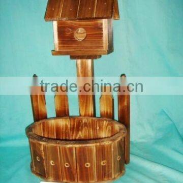 burned wooden planter with bird house