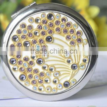 round compact mirror with blue rhinestone in the center