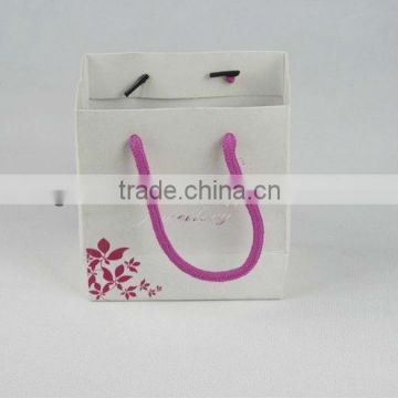 Creative paper bag with pink handle