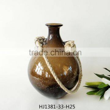 Glass bottle with rope