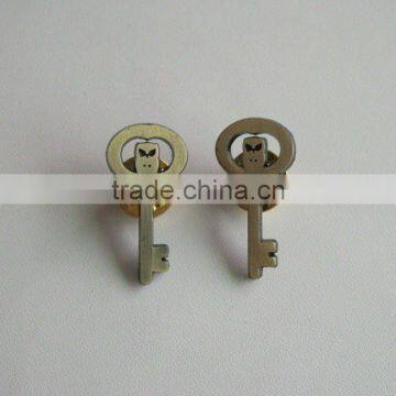 Key shape metal badge