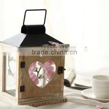 The heart shape in the middle of the handing galss wooden candle lanterns