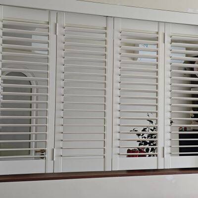 white color 100% custom made basswood window shutter bi-folding panels with tracking rail