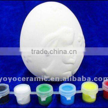 easter egg unpainted white ceramic bisque with pigment and brush