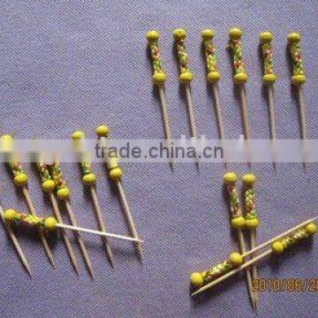 two beaded bamboo skewers