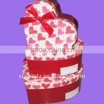 Heart shaped cardboard gift box with red satin bowknot