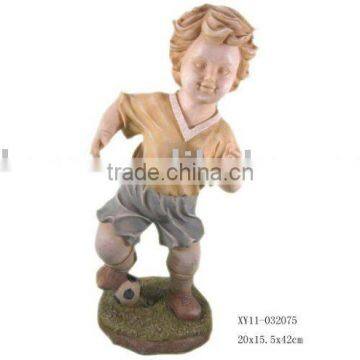 Polyresin boy figurine with football