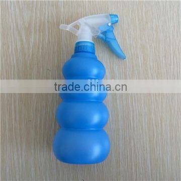 blue plastic garden spray bottle with trigger