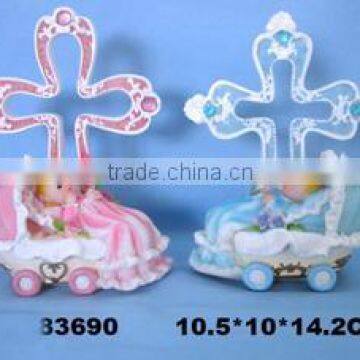 Baby on crib w/cross decoration