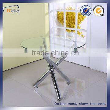 Round glass dining table with 3 metal legs