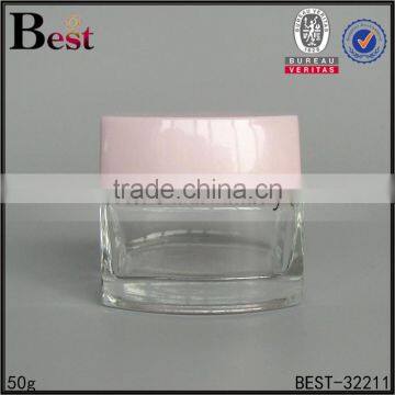 China Cosmetics 50 ml Glass Jar Clear Transparent Square Glass Jar With Pink Cap Manufacture