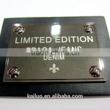 laser logo on metal plate jeans leather label