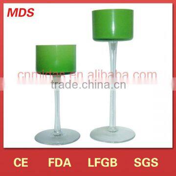 Goblet-shaped green candle holder with clear stem