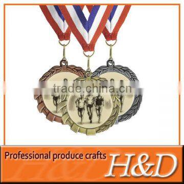 antique award medal with three people print and ribbon
