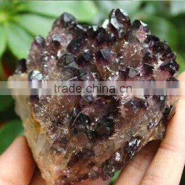 Natural small pyramid end prism with purple point crystal cluster covered with rime