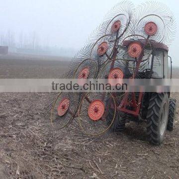 round disc rakes trailed by tractor